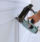 Carpenter using a brad nail gun to complete framing trim Air gun for nailing