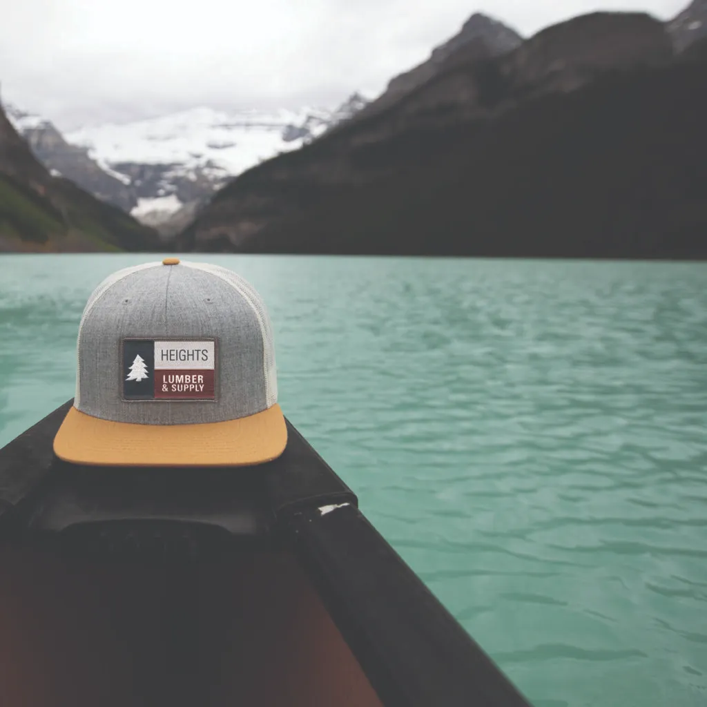 Heights Lumber branded hat on a canoe