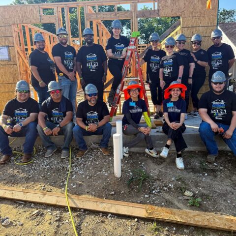 Moss Utilities volunteers in custom Building Stronger Communities DTF printed tees at a home build